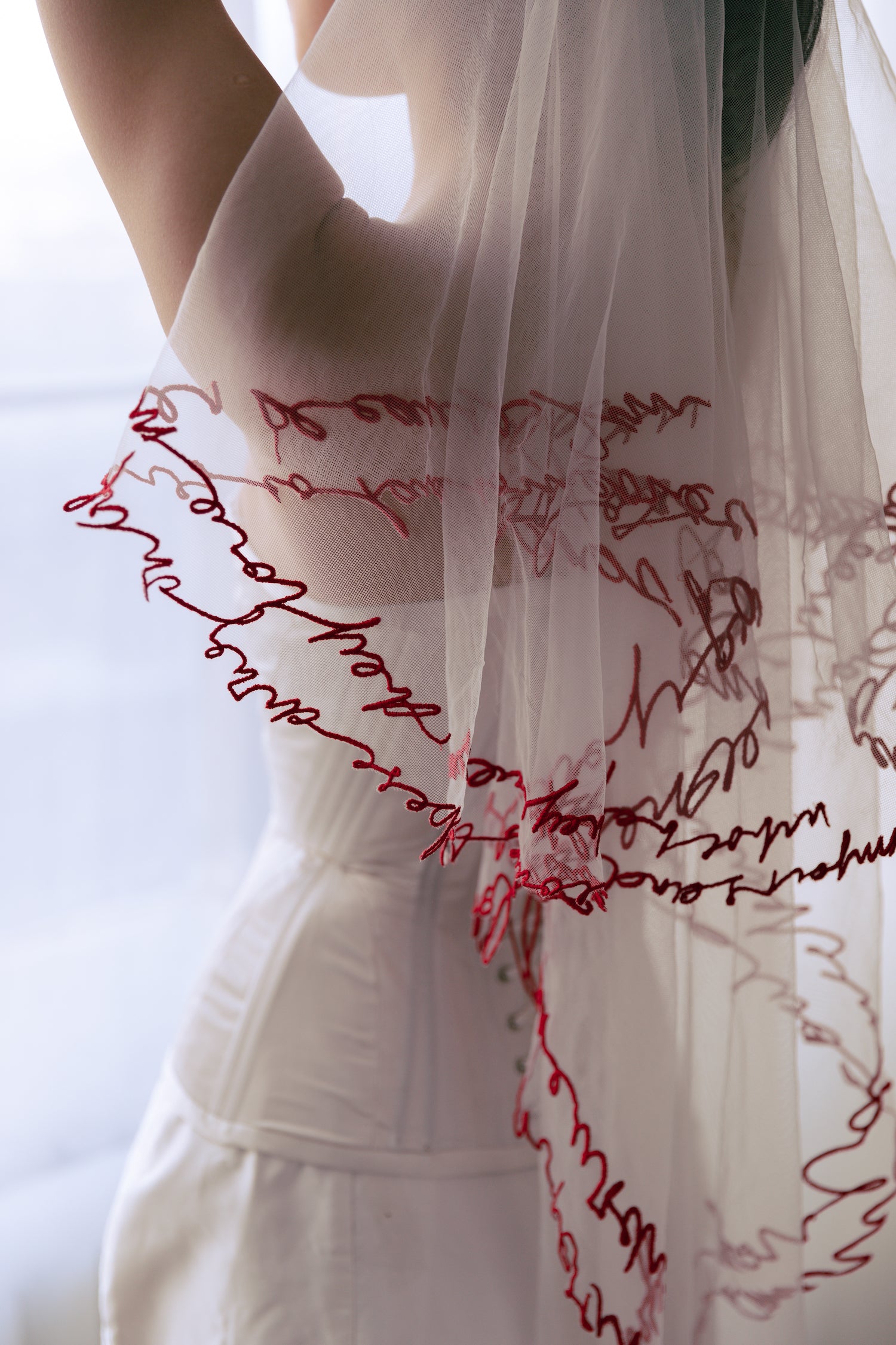 atelier arielle residency in los angeles with mae bridal. pictured romantic veil with red endge with love letter.