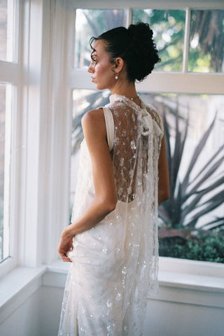 Claire La Faye Cosette Overlay Dress on model, side at Mae Bridal, sequin bridal overlay, second look wedding dress, bridal topper