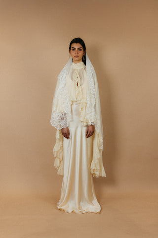 Théoro Matadero Cape worn over a slip dress at Mae Bridal, bridal cape, silk chiffon cape, cape wedding gown