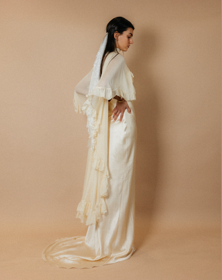 Théoro Matadero Cape ruffle close up at Mae Bridal, bridal cape, silk chiffon cape, cape wedding gown