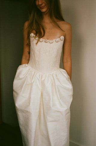 White dress with floral details on a plain background