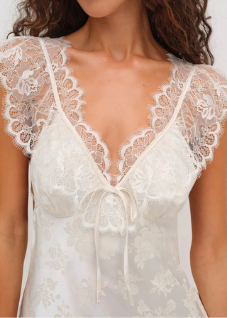 White lace dress with a deep neckline on a white background