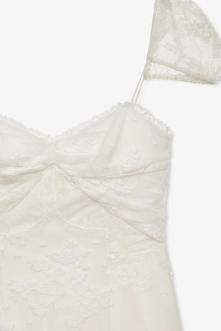 Close-up of a white strapless dress with textured fabric on a white background